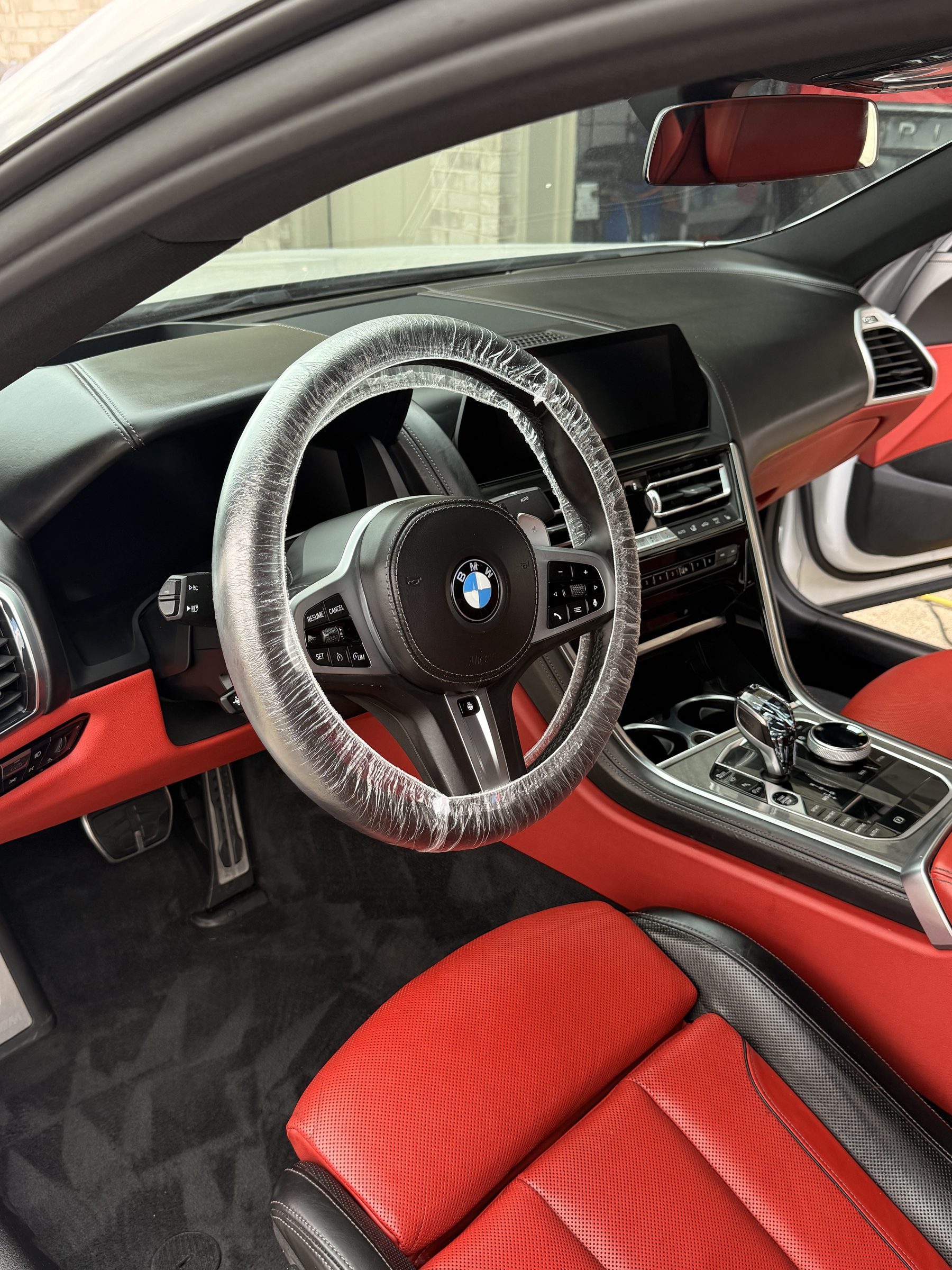 BMW 8-series red and black leather interior being detailed at Top Auto Detailing